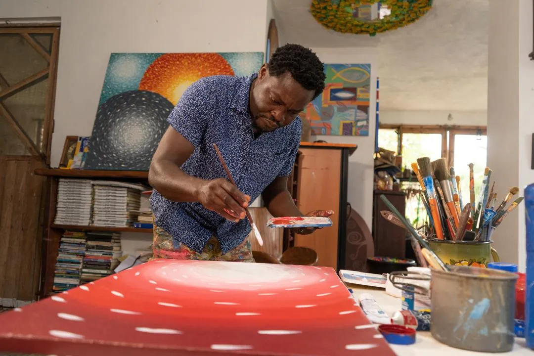 Kobina Nyarko painting in his studio